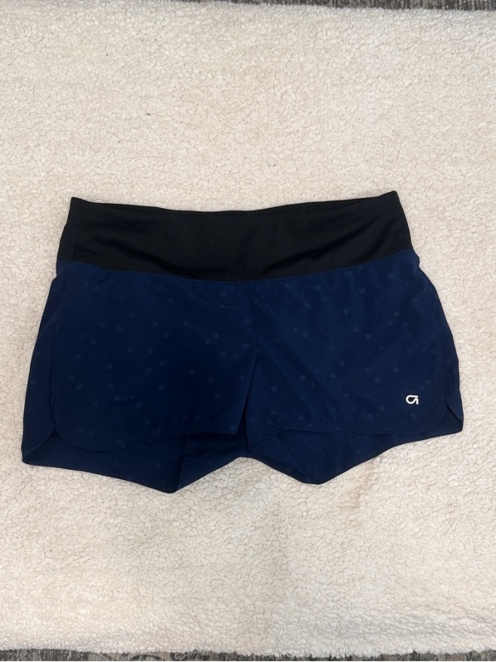GAP navy athletic shorts with black waistband and subtle star pattern